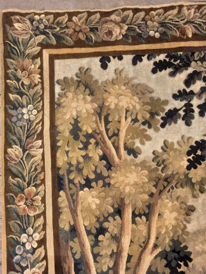 null Green tapestry representing a wooded landscape with two wading birds in the...