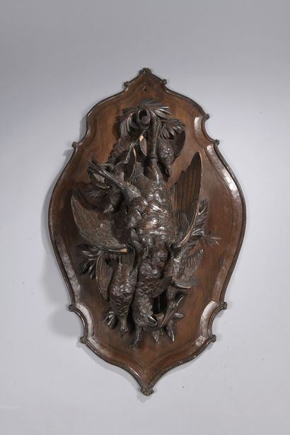 null Suite of three medallions in wood carved in high relief of animal trophies,...