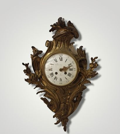 Wall clock in gilt bronze and chased with...