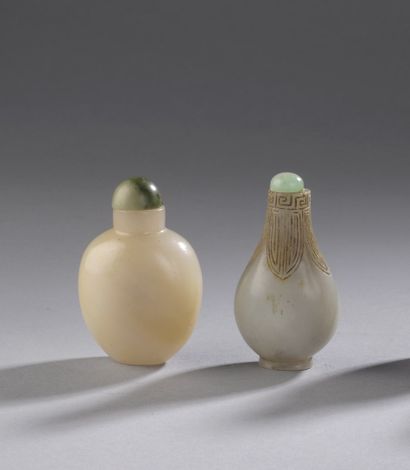 null CHINA - 20th century

Two nephrite snuff bottles, one piriform with archaic...