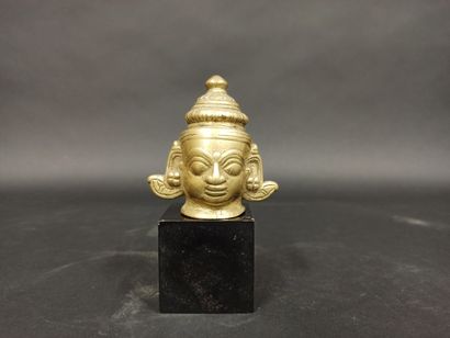 null Shiva lingam in bronze with golden patina, showing a male head.

India, 19th...