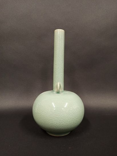 null Celadon stoneware vase with globular body, long neck and ring handle.

China,...