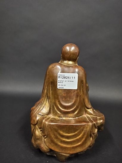null Arahat in bronze in a relaxing position sitting on a rock.

China, 20th century

H....