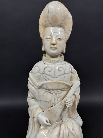 null Statuette in white porcelain representing a musician kneeling on a rock.

China,...