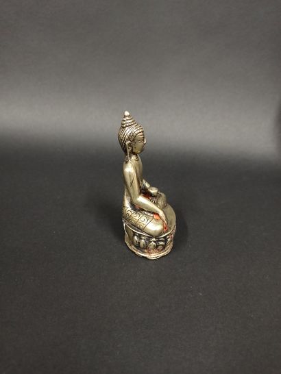 null Small silver Buddha represented in the gesture of taking the earth as a witness...