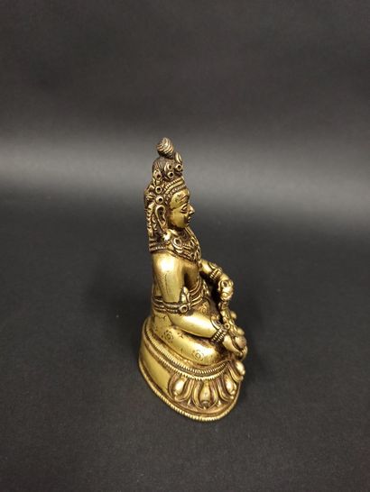 null Statuette in gilded bronze representing Kubera holding in his hand a mongoose...