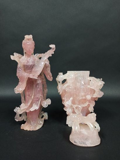 null Meeting of two subjects in carved rose quartz, the first representing a musician,...