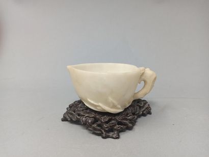 null White hardstone cup stylizing a peach of longevity, a flowering branch accompanied...