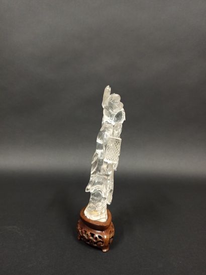null Rock crystal guanine holding a lantern at the end of a stick in one hand and...