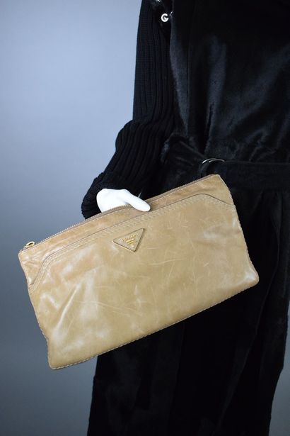 PRADA 
 
Clutch bag in aged natural leather,...