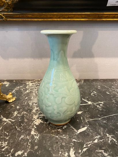 null Small celadon stoneware piriform vase decorated with friezes of lotus flowers.

China,...