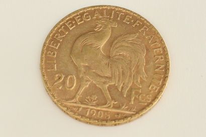 null Gold coin of 20 Francs with rooster (1905).

Weight : 6.43 g.