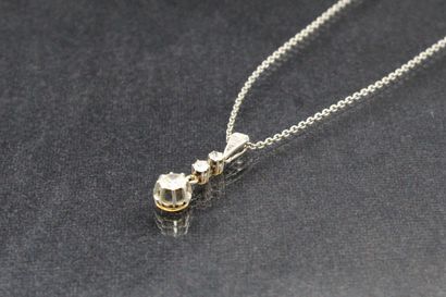 null Pendant and its chain in 18K (750) gold and platinum decorated with two small...
