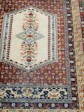 null Wool carpet with ivory background and decoration of a frieze of foliage, red...