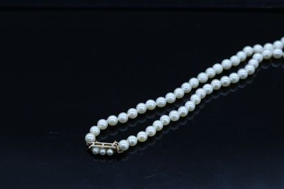 null Necklace of cultured pearls, adorned with engraved coral balls and gold ferrules,...