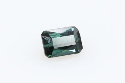 null Green tourmaline with cut sides on paper. 

Weight : 1.88 cts.