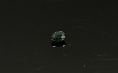 null Green tourmaline pear on paper. 

Weight : 1.60 cts.