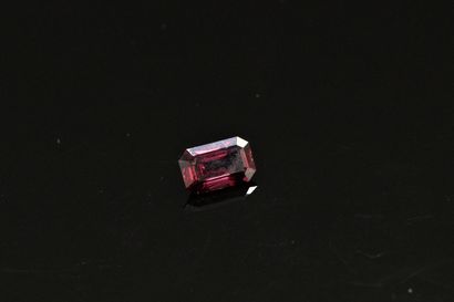 null Rectangular red spinel with cut sides on paper.

Weight : 1.67 cts.