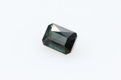 null Green tourmaline with cut sides on paper. 

Weight : 1.88 cts.