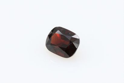 null Cushion red spinel on paper. 

Weight : 1.89 cts.