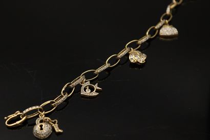 null Bracelet en or jaune 18K (750) orné de breloques en forme de cadenas, poisson,...