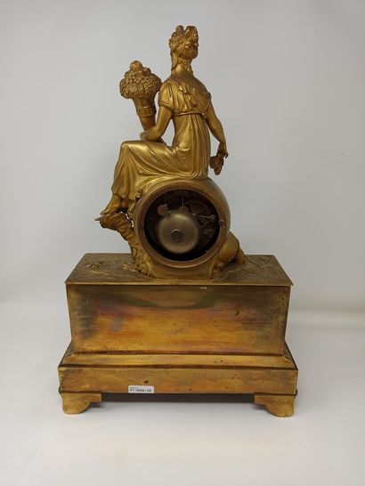 null Clock with Abundance

in gilded bronze, consisting of a high base decorated...