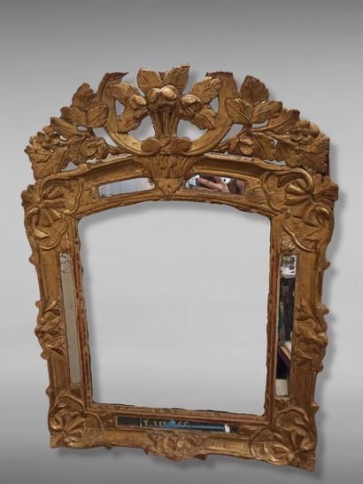 null Carved and gilded wood mirror with fleurons decoration, the upper part slightly...