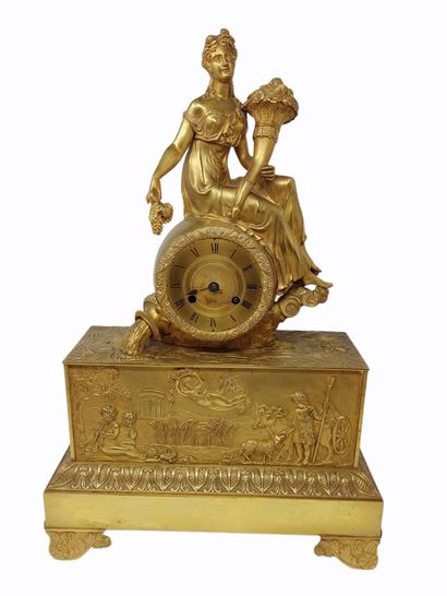 null Clock with Abundance

in gilded bronze, consisting of a high base decorated...