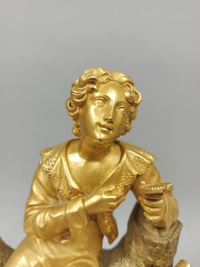 null Gilt bronze clock depicting a man sitting on a tree trunk and holding in his...