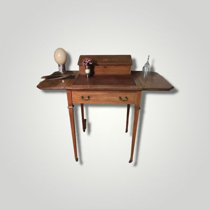 null Table en bois de placage ouvrant à deux abattants découvrant un plateau en cuir...