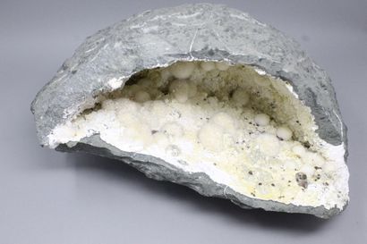 null Okenite, Gyrolite, Apophyllite. Large elongated geode with okenite in white...