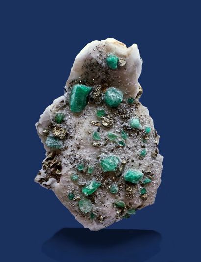 null Emerald (beryl), pyrite: 30 translucent green hexagonal crystals (up to 15mm)...