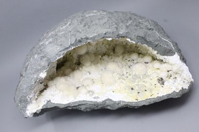 null Okenite, Gyrolite, Apophyllite. Large elongated geode with okenite in white...