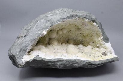 null Okenite, Gyrolite, Apophyllite. Large elongated geode with okenite in white...