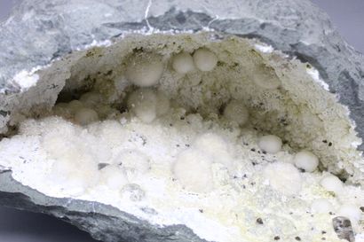 null Okenite, Gyrolite, Apophyllite. Large elongated geode with okenite in white...