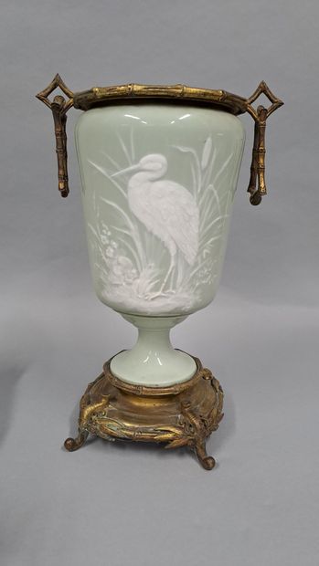 null Pair of celadon porcelain vases with white relief decoration of waders, brass...