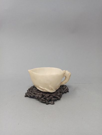 null White hardstone cup stylizing a peach of longevity, a flowering branch accompanied...