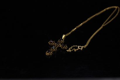 null 18k (750) yellow gold chain with a cross pendant in 18k (750) yellow gold adorned...