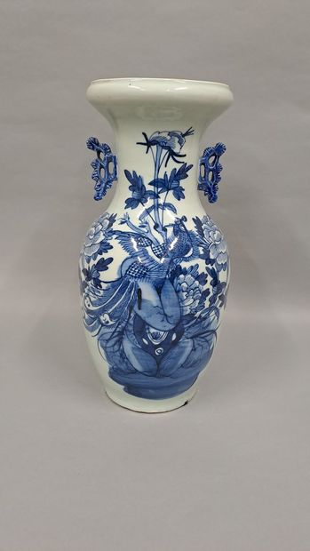 null Porcelain vase of baluster form with blue decoration of a peacock among peonies...