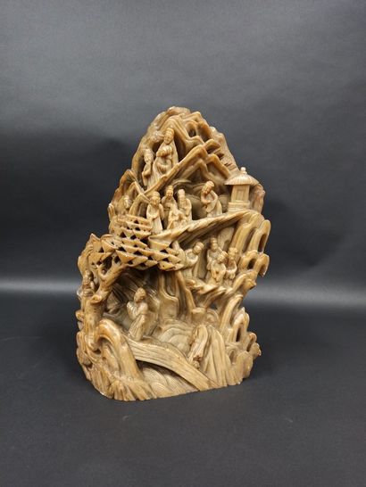 null Important group in carved brown soapstone representing characters in a mountain...