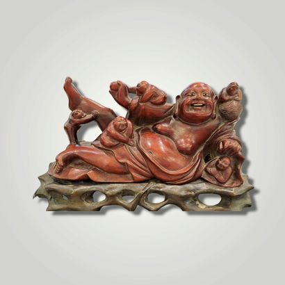 null 
Wooden group featuring a reclining laughing Buddha surrounded by children.

China,...