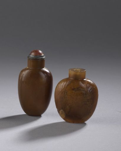 null CHINA - 19th/20th century

Two caramel agate snuff bottles, one carved in light...