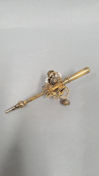 null Silver gilt rattle-whistle with five bells held by foliage scrolls in console.

18th...