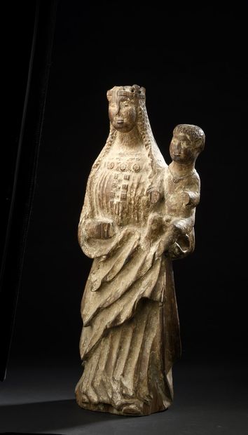 null Virgin and Child in wood carved in the round. Standing with her head crowned,...