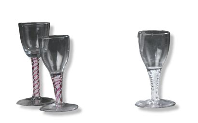 null Set of three stemmed glasses in the English style, with pink twist leg for two...