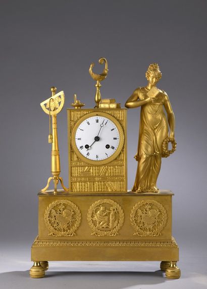 null Gilt bronze clock resting on a high rectangular base decorated with reliefs...