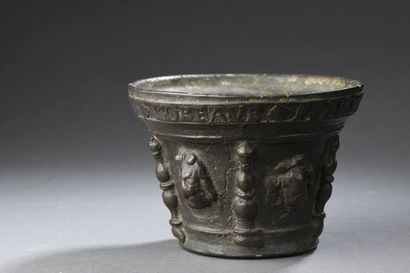 null Bronze mortar with four baluster buttresses and various mascarons; rim inscribed...