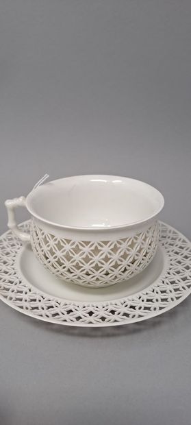 null SEVRES 
Part of tea service in white porcelain reticulated whose handle simulates...
