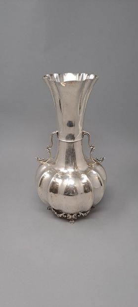 null Vase with long flared neck in silver (800) with a gadrooned body resting on...