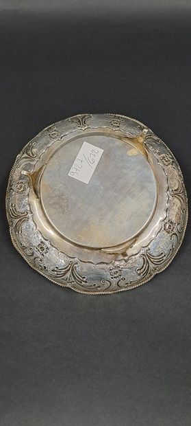 null Tripod silver bowl with floral motifs on a lightly hammered background, the...